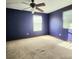 Bedroom with dark purple walls, carpet flooring, and a ceiling fan at 615 S Laurel Ave, Sanford, FL 32771