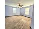 Bedroom with carpet, two windows, and a ceiling fan providing natural light at 615 S Laurel Ave, Sanford, FL 32771