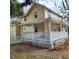 Charming two-story yellow home featuring a spacious front porch and a well-maintained yard at 615 S Laurel Ave, Sanford, FL 32771