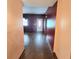 Long hallway leading to a bright room and front door, showcasing sleek hardwood flooring at 615 S Laurel Ave, Sanford, FL 32771