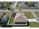 View of a home featuring a well-maintained lawn and a white fenced-in backyard with screened in patio at 702 Pelican Ct, Kissimmee, FL 34759