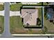 Aerial view of a single-story home featuring a well-maintained lawn and a fenced-in backyard with screened in patio at 702 Pelican Ct, Kissimmee, FL 34759