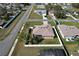 Aerial view of a single-story home featuring a fenced-in backyard with screened in patio at 702 Pelican Ct, Kissimmee, FL 34759