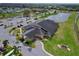 Aerial view of community building with lush landscaping and signage at 702 Pelican Ct, Kissimmee, FL 34759