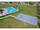 Community amenities featuring a pool, pool house, basketball court and large grassy fields at 702 Pelican Ct, Kissimmee, FL 34759
