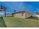 Well-maintained backyard with green lawn and a privacy fence at 702 Pelican Ct, Kissimmee, FL 34759