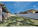 Spacious backyard with lush green grass and white fence at 702 Pelican Ct, Kissimmee, FL 34759