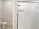 Modern bathroom with a glass-enclosed shower, toilet, and neutral color scheme at 702 Pelican Ct, Kissimmee, FL 34759