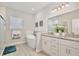 Elegant bathroom with a soaking tub, dual vanities with granite countertops, and a glass-enclosed shower at 702 Pelican Ct, Kissimmee, FL 34759