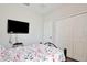 Cozy bedroom featuring a full bed, television, and ample closet space at 702 Pelican Ct, Kissimmee, FL 34759