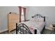 Charming bedroom with a bed, dresser, and a window with patterned curtains at 702 Pelican Ct, Kissimmee, FL 34759