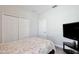 Comfortable bedroom featuring wood-look floors, a closet, and a television for entertainment at 702 Pelican Ct, Kissimmee, FL 34759