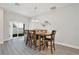 Bright dining room with hardwood floors, large windows, and a wooden table with seating for six at 702 Pelican Ct, Kissimmee, FL 34759