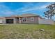 Beautiful home featuring a well-manicured lawn and a white fence in the backyard at 702 Pelican Ct, Kissimmee, FL 34759