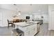 Open-concept kitchen featuring granite countertops, stainless steel appliances, and a view of the living and dining area at 702 Pelican Ct, Kissimmee, FL 34759