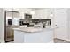 Modern kitchen with stainless steel appliances, granite countertops, and a tile backsplash at 702 Pelican Ct, Kissimmee, FL 34759