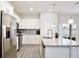 Modern kitchen with stainless steel appliances, granite countertops, and white cabinets at 702 Pelican Ct, Kissimmee, FL 34759