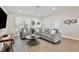 Cozy living room with hardwood floors, a plush sofa, and a large window with curtains at 702 Pelican Ct, Kissimmee, FL 34759