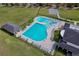 Aerial view of a community pool with lap lanes, a slide, a basketball court, and a pool house at 702 Pelican Ct, Kissimmee, FL 34759