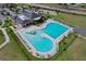 Community pool aerial view showcasing the recreational area with a slide, lap lanes, and ample seating at 702 Pelican Ct, Kissimmee, FL 34759