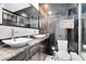 Modern bathroom featuring black tile, dual sinks, and shower with glass door at 726/720 N Pennsylvania Ave, Winter Park, FL 32789