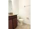 Bathroom featuring a toilet, vanity with granite countertop, and wood cabinets at 7681 Fordson Ln, Windermere, FL 34786