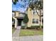 Inviting two-story townhome featuring well-maintained landscaping and neutral color palette at 7681 Fordson Ln, Windermere, FL 34786