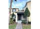 Charming townhome featuring a covered front porch and neatly manicured landscaping at 7681 Fordson Ln, Windermere, FL 34786