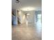 Bright and airy living room with neutral ceramic tile flooring and access to staircase at 7681 Fordson Ln, Windermere, FL 34786