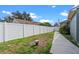 Fenced backyard offers privacy for outdoor entertaining and relaxation, and has a walkway along the side of the house at 8519 Rainbow Ave, Orlando, FL 32825