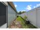 Narrow side yard with partial brick path at 8519 Rainbow Ave, Orlando, FL 32825