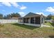 Exterior view of screened in patio and fenced in yard at 8519 Rainbow Ave, Orlando, FL 32825