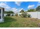 A large, grassy backyard with a white fence, offering a private outdoor space at 8519 Rainbow Ave, Orlando, FL 32825