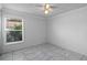Bright bedroom with large window and marble-style tile floors at 8519 Rainbow Ave, Orlando, FL 32825
