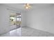 Well lit bedroom with tiled floors and sliding glass doors to covered patio at 8519 Rainbow Ave, Orlando, FL 32825