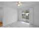 Well lit bedroom featuring tiled floors and sliding glass doors to covered patio at 8519 Rainbow Ave, Orlando, FL 32825