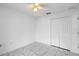 Bright bedroom featuring tiled floors, ceiling fan, and closet with sliding doors at 8519 Rainbow Ave, Orlando, FL 32825