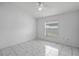 Minimal bedroom featuring ceiling fan, window and marble-style tile floors at 8519 Rainbow Ave, Orlando, FL 32825