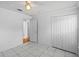 Clean bedroom with closet, ceiling fan and white marble-style tile floors at 8519 Rainbow Ave, Orlando, FL 32825