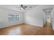 Bright bedroom featuring tile flooring, a ceiling fan and a large window at 8519 Rainbow Ave, Orlando, FL 32825