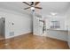 Bright living room featuring tile flooring, a ceiling fan and a pass-through to the kitchen at 8519 Rainbow Ave, Orlando, FL 32825