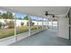 Spacious covered patio with dual ceiling fans and screened enclosure overlooking backyard at 8519 Rainbow Ave, Orlando, FL 32825