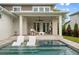 Backyard with in-pool loungers, pool, and jacuzzi with view of the covered patio at 9454 Becker Ct, Orlando, FL 32827