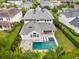 Stunning backyard view features a sparkling pool, spa, travertine patio, and lush landscaping at 9454 Becker Ct, Orlando, FL 32827