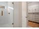 Bathroom featuring a marble shower with glass door and brass fixtures next to a walk-in closet with custom shelving at 9454 Becker Ct, Orlando, FL 32827