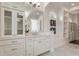 Elegant primary bath with white cabinetry, marble countertop and a view to shelving at 9454 Becker Ct, Orlando, FL 32827