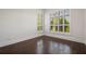 Bright bedroom showcasing hardwood floors, plantation shutters, and trim at 9454 Becker Ct, Orlando, FL 32827