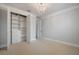 Bright bedroom with a chandelier, large closet, carpet, and neutral walls at 9454 Becker Ct, Orlando, FL 32827