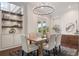 Dining room featuring built in cabinets, shelves and a modern chandelier over a dining table at 9454 Becker Ct, Orlando, FL 32827