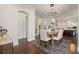 Dining area with modern chandelier and views into the kitchen at 9454 Becker Ct, Orlando, FL 32827